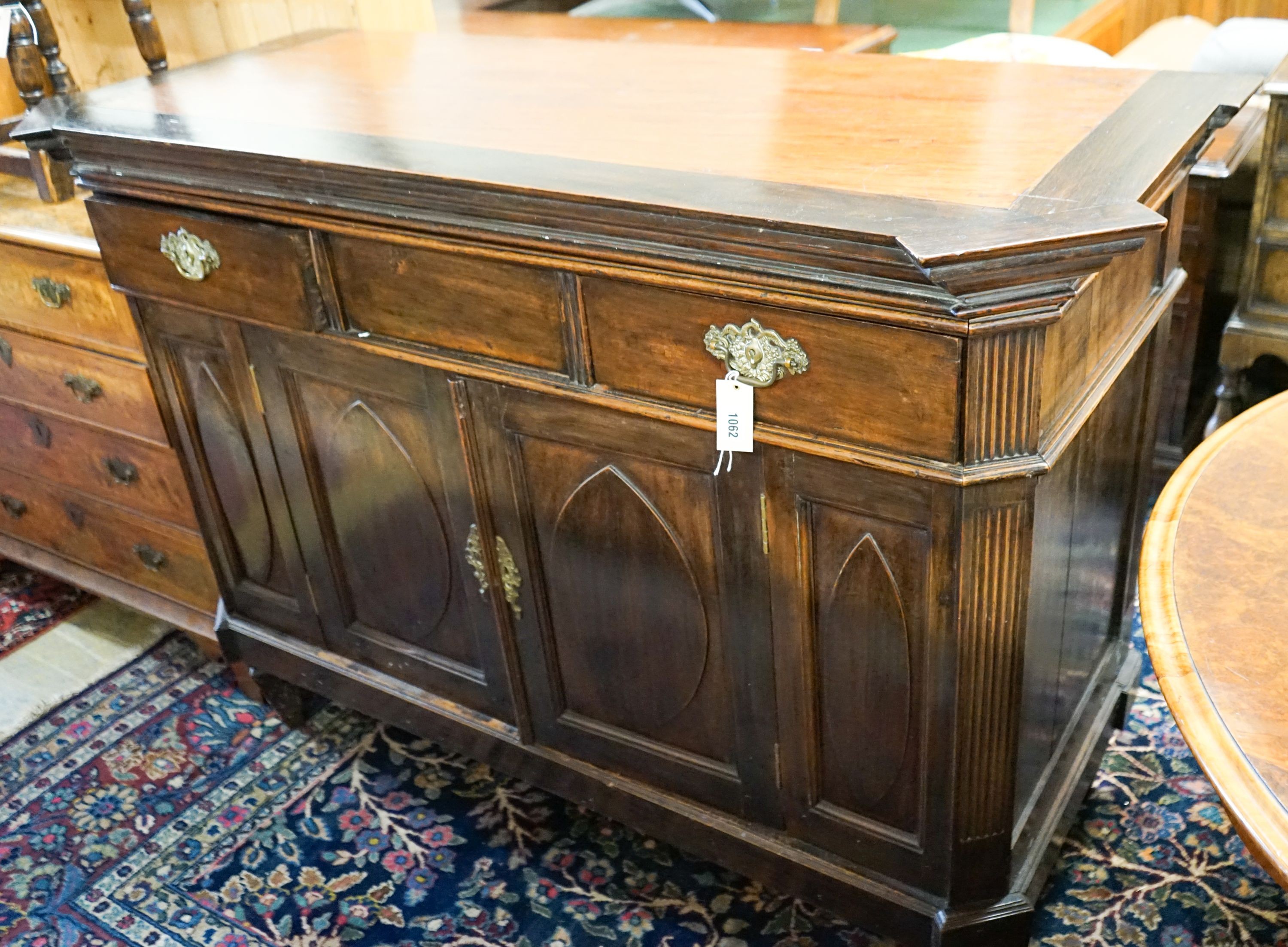 A 19th century Dutch mahogany sideboard, length 136cm, depth 56cm, height 104cm with raised shelved back over two frieze drawers and a pair of 'Gothic'-panelled cupboard doors, the top inset a pewter bowl